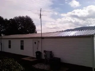 New metal roof on a single wide mobile home with a TV antenna in Pittsburgh