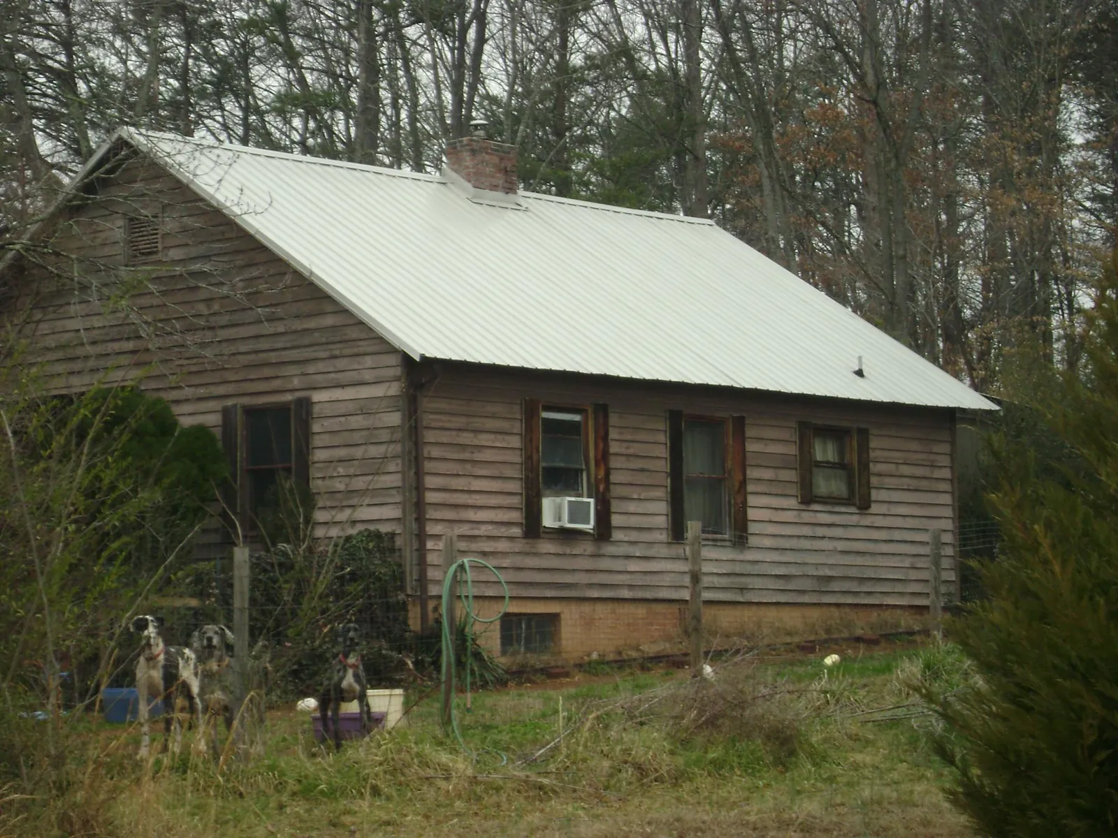 White metal roof on an old wood sided farmhouse, from a Metal Roof Installation job in Pittsburgh